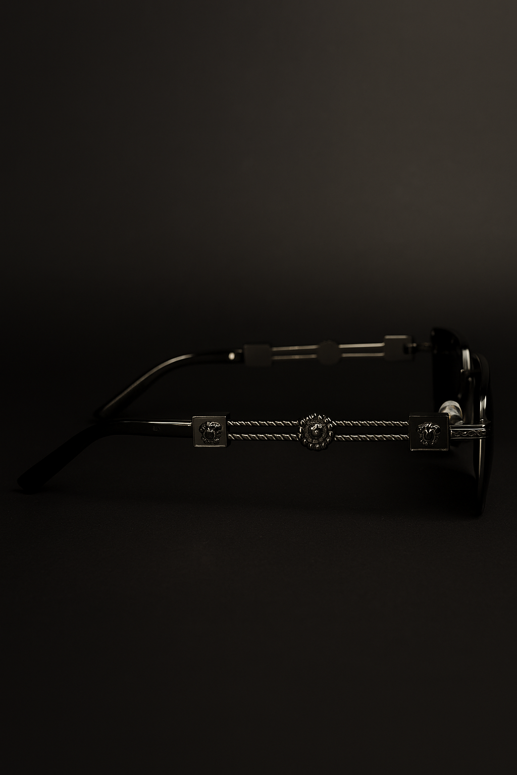 Sunglasses with a decorative metal bridge on a black background