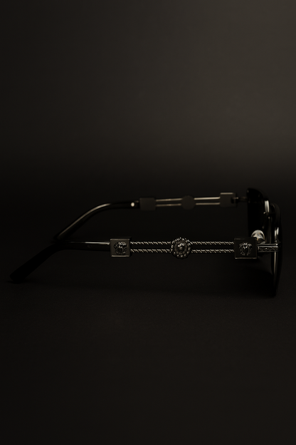 Sunglasses with a decorative metal bridge on a black background