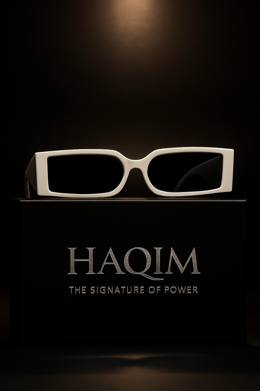 Sunglasses on a black stand with 'HAQIM' branding in the background