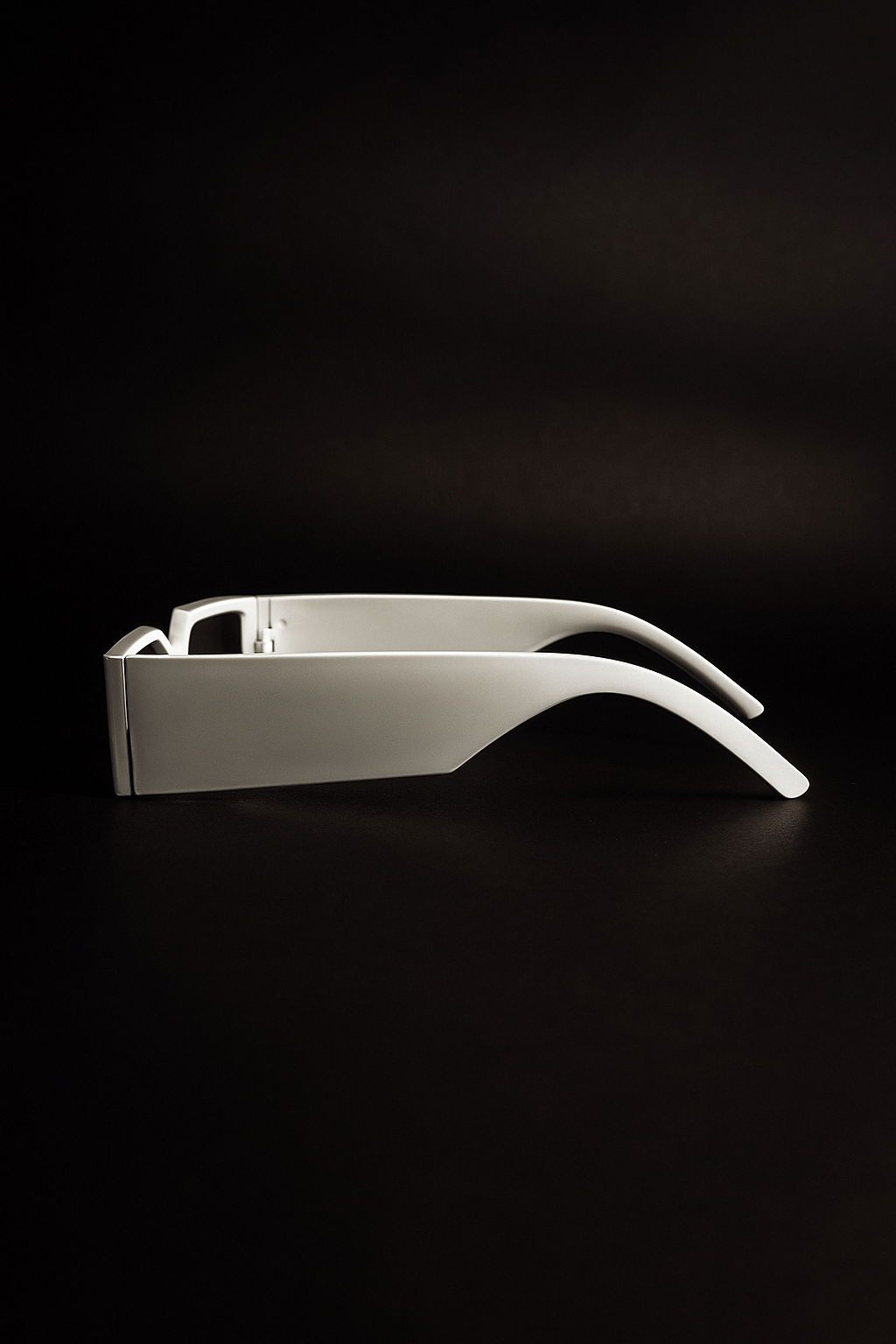 White sunglasses on a black background