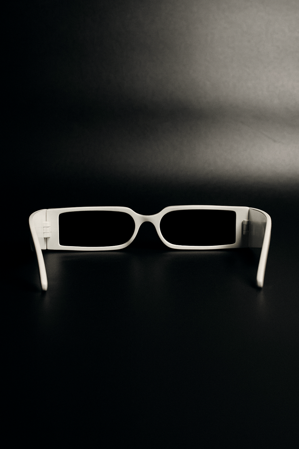 White sunglasses on a black background